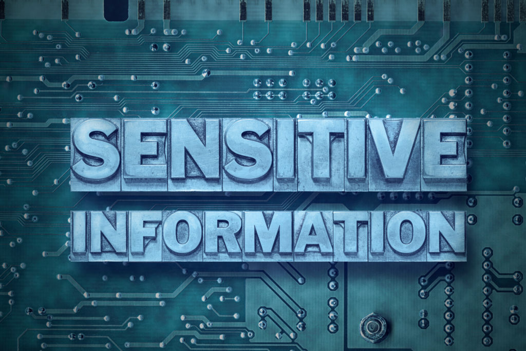 The words Sensitive Information shown over a computer circuit board.